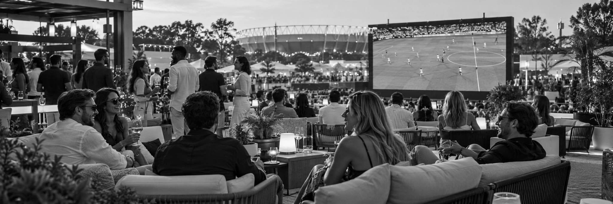 Guests relaxing in an open-air VIP soccer fan lounge