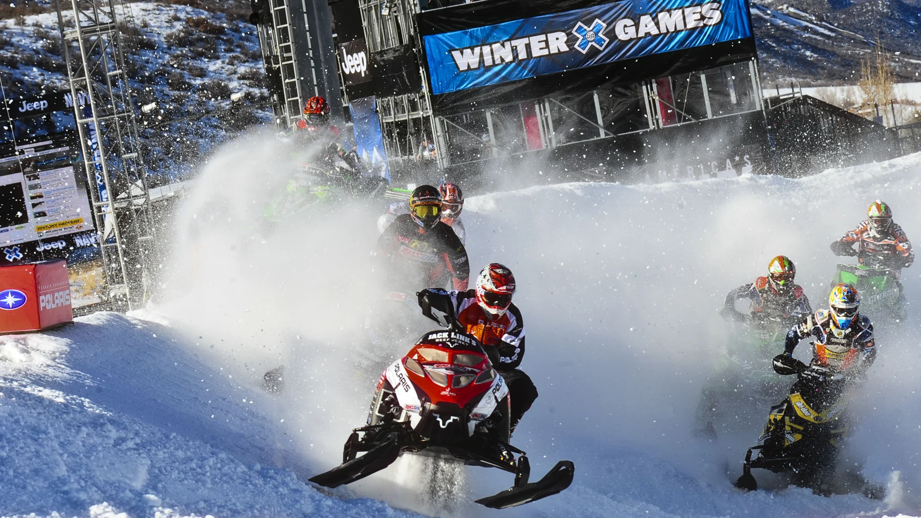 Snowmobile competitors racing at the Winter X Games