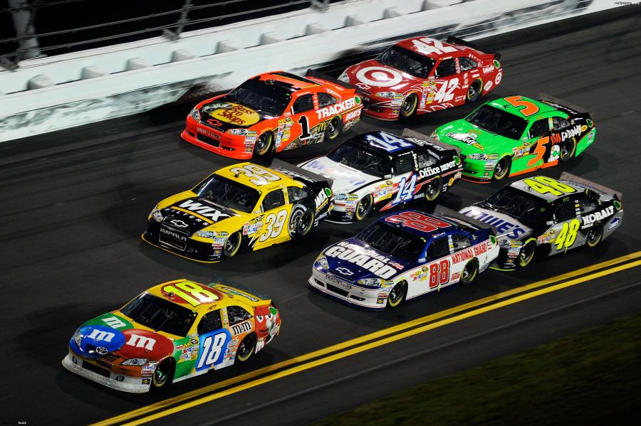NASCAR stock cars racing together on the track